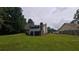 Expansive backyard view featuring a screened-in porch, patio, and mature trees at 2477 Briar Valley Way, Dacula, GA 30019