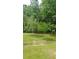 The property features mature trees and landscaping that makes it a beautiful space at 2477 Briar Valley Way, Dacula, GA 30019
