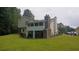 Backyard featuring a screened-in porch, a brick chimney, and a well-maintained lawn at 2477 Briar Valley Way, Dacula, GA 30019