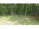 The backyard has a wooded backdrop with a bench to relax and take it all in at 2477 Briar Valley Way, Dacula, GA 30019