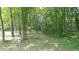 The backyard is surrounded by a forest-like landscape and lots of greenery at 2477 Briar Valley Way, Dacula, GA 30019