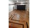 Basement bar area with decorative hardwood floors and dark wood bar at 2477 Briar Valley Way, Dacula, GA 30019