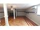 Spacious basement features hardwood floors, ceiling fans, and wooden trim details at 2477 Briar Valley Way, Dacula, GA 30019