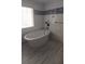 Modern bathroom featuring a freestanding tub, tiled walls, mosaic accent and tile flooring at 2477 Briar Valley Way, Dacula, GA 30019