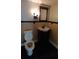 Bathroom with dark tile flooring, vanity sink, and toilet at 2477 Briar Valley Way, Dacula, GA 30019