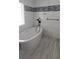 Bright bathroom with sleek fixtures, a standalone tub, and modern tile flooring, perfect for relaxation at 2477 Briar Valley Way, Dacula, GA 30019