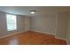 Spacious bedroom featuring hardwood floors, a bright window, and neutral walls, perfect for relaxation at 2477 Briar Valley Way, Dacula, GA 30019