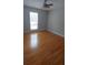 Cozy bedroom featuring neutral walls, hardwood flooring, and a window for natural light at 2477 Briar Valley Way, Dacula, GA 30019