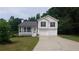 Charming split-level home with a welcoming front porch and a two-car garage at 2477 Briar Valley Way, Dacula, GA 30019