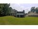 Back exterior view of the home with a chimney and a screened-in back porch at 2477 Briar Valley Way, Dacula, GA 30019