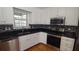 Modern kitchen featuring stainless steel appliances, granite countertops, and sleek cabinetry at 2477 Briar Valley Way, Dacula, GA 30019