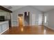Spacious living room featuring hardwood floors, neutral paint, and access to the kitchen and stairs at 2477 Briar Valley Way, Dacula, GA 30019