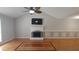Spacious living room boasts a vaulted ceiling, fireplace, and beautiful hardwood floors at 2477 Briar Valley Way, Dacula, GA 30019