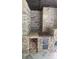 Well-equipped outdoor kitchen area with stone features and storage for wood and cooking equipment at 2477 Briar Valley Way, Dacula, GA 30019