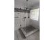 Stylish shower with glass enclosure, dual shower heads, modern tile work and mosaic accent at 2477 Briar Valley Way, Dacula, GA 30019