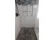 Modern shower features stylish tile, stone floor and practical built-in shelves for a spa-like feel at 2477 Briar Valley Way, Dacula, GA 30019