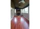 Bright sunroom with a fireplace, TV, windows, and wood-look flooring at 2477 Briar Valley Way, Dacula, GA 30019