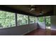 Bright sunroom with hardwood floors, ceiling fans, and multiple windows at 2477 Briar Valley Way, Dacula, GA 30019