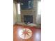 Sunroom features a stone fireplace with TV, hardwood floors, and natural light at 2477 Briar Valley Way, Dacula, GA 30019