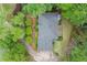 Aerial view of a house surrounded by lush greenery, showcasing the roof, driveway, and landscaping at 4433 Windsor Oaks Cir, Marietta, GA 30066