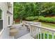 Relaxing back deck featuring outdoor seating, a white railing, and a view of the lush green backyard and mature trees at 4433 Windsor Oaks Cir, Marietta, GA 30066