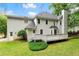 Spacious backyard showing a well-maintained lawn, a large deck, and a home with a neutral-colored exterior at 4433 Windsor Oaks Cir, Marietta, GA 30066