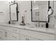 Bathroom features dual sinks with white marble countertops, white cabinets, and black hardware, plus modern fixtures at 4433 Windsor Oaks Cir, Marietta, GA 30066