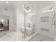 Bright bathroom featuring a free-standing tub, a glass shower, a skylight, and marble floors, plus a walk-in closet at 4433 Windsor Oaks Cir, Marietta, GA 30066
