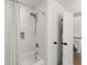 Bright bathroom featuring a tiled shower with adjustable shower head and white shower curtain at 4433 Windsor Oaks Cir, Marietta, GA 30066