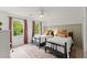 Comfortable bedroom featuring two twin beds, a ceiling fan, soft carpet, and a window view at 4433 Windsor Oaks Cir, Marietta, GA 30066