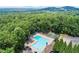 Aerial view showcasing the neighborhood pool, pickleball courts, and surrounding lush greenery at 4433 Windsor Oaks Cir, Marietta, GA 30066