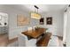 Elegant dining room with a wooden table, upholstered chairs, and modern lighting fixture at 4433 Windsor Oaks Cir, Marietta, GA 30066