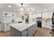 Modern kitchen featuring quartz countertops, stainless steel appliances, and an island with seating at 4433 Windsor Oaks Cir, Marietta, GA 30066