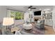 Cozy living room with a fireplace, built-in shelving, comfortable seating, and large windows at 4433 Windsor Oaks Cir, Marietta, GA 30066