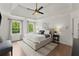 Bright main bedroom suite featuring hardwood floors, tray ceiling, a ceiling fan and large windows for natural light at 4433 Windsor Oaks Cir, Marietta, GA 30066