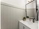 Stylish powder room with board and batten walls, a modern vanity, and decorative mirror at 4433 Windsor Oaks Cir, Marietta, GA 30066