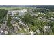 Wide aerial view of homes surrounding a lake surrounded by lush green trees and foliage at 6805 Bucks Rd, Cumming, GA 30040