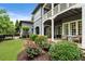 Spacious backyard with lush landscaping, a charming patio, and a view of the home's exterior at 6805 Bucks Rd, Cumming, GA 30040