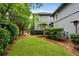 Spacious backyard with manicured lawn and mature trees provides privacy and serenity, perfect for relaxing and entertaining outdoors at 6805 Bucks Rd, Cumming, GA 30040