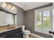 The bathroom offers a granite countertop, neutral paint, and natural light, creating a clean and comfortable space at 6805 Bucks Rd, Cumming, GA 30040