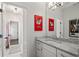 Bright bathroom with white vanity, granite countertop and unique wall art at 6805 Bucks Rd, Cumming, GA 30040