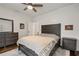 Cozy bedroom featuring a wood-accent wall, ceiling fan, and stylish furniture at 6805 Bucks Rd, Cumming, GA 30040