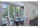 Bright dining area with large windows providing lush backyard views, adjacent to the kitchen at 6805 Bucks Rd, Cumming, GA 30040