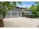 Charming gray two-story home featuring a three-car garage and inviting upper-level balcony at 6805 Bucks Rd, Cumming, GA 30040