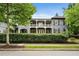 Elegant two-story home with a covered balcony, complimented by lush green landscaping at 6805 Bucks Rd, Cumming, GA 30040