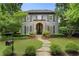 Stately two-story home with stone archway, complemented by a well-manicured lawn at 6805 Bucks Rd, Cumming, GA 30040