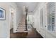 Bright hallway with hardwood floors, white trim, and a staircase leading to the upper level at 6805 Bucks Rd, Cumming, GA 30040