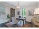 Elegant home office featuring a chandelier, built-in bookcase, and a large window with natural light at 6805 Bucks Rd, Cumming, GA 30040