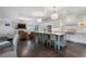 Open-concept kitchen boasts a large center island with seating and stainless steel appliances, flowing into the living space at 6805 Bucks Rd, Cumming, GA 30040