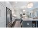 Well-lit kitchen with a large center island, modern stainless steel appliances, and white cabinetry for ample storage at 6805 Bucks Rd, Cumming, GA 30040